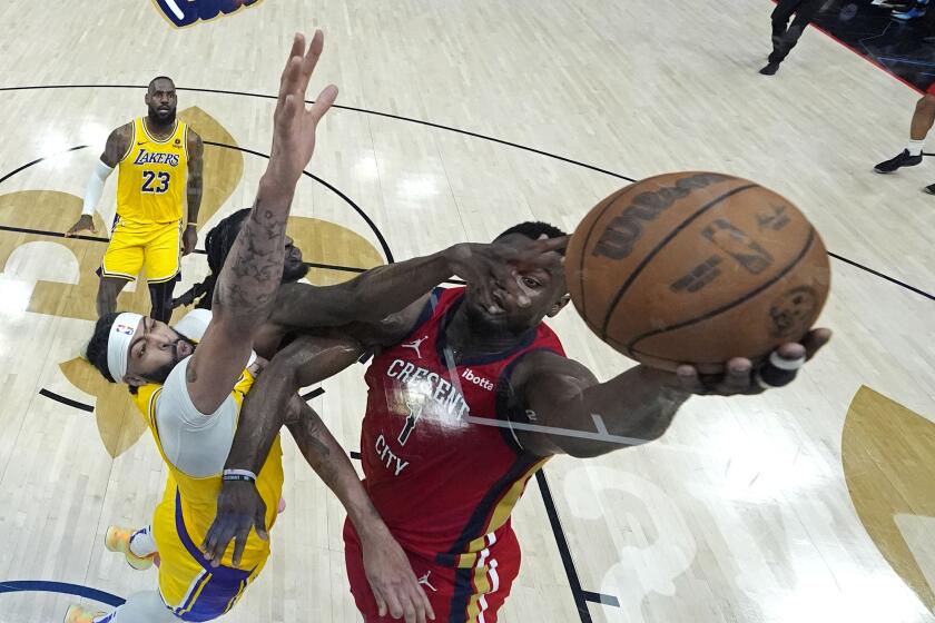 FILE - New Orleans Pelicans forward Zion Williamson (1) goes to the basket against Los Angeles Lakers forward Anthony Davis and forward Taurean Prince in the first half of an NBA basketball play-in tournament game Tuesday, April 16, 2024, in New Orleans. Looking on at rear left is Lakers' LeBron James.(AP Photo/Gerald Herbert)