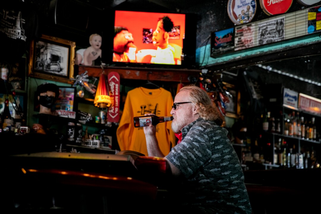 Bruce Grizer sips a cold beer inside The Tower Bar.