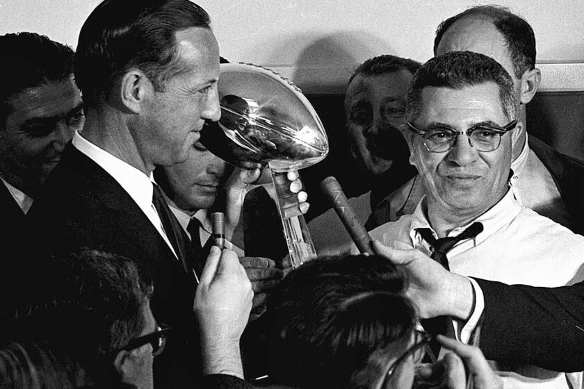 FILE - In this Jan. 15, 1967, file photo, football commissioner Pete Rozelle, left, presents the trophy to Green Bay Packers coach Vince Lombardi after they beat the Kansas City Chiefs 35-10 in Super Bowl I in Los Angeles. (AP Photo, File)