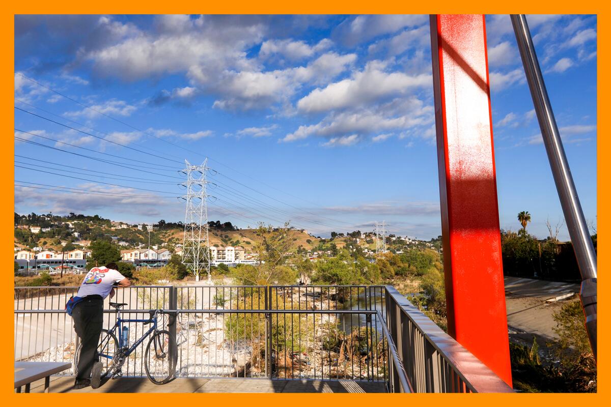 A bicyclist takes in the view from one of two observation decks on the Taylor Yard Bridge over the Los Angeles River.