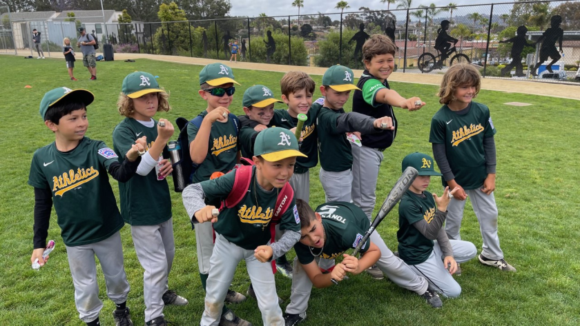 Solana Beach Little League Athletics team members celebrate their victory.