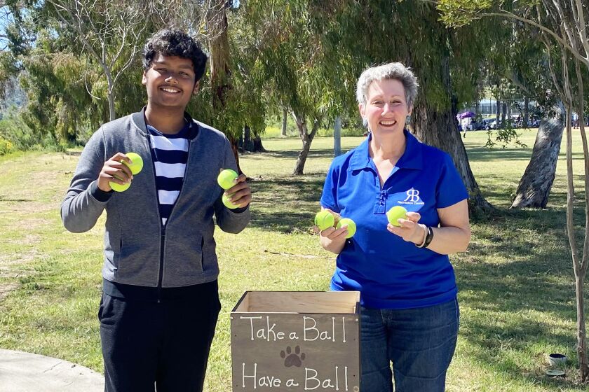 Ayush Jaiswal and RB Community Recreation Group President Robin Kaufman with one of the dog ball libraries he made.