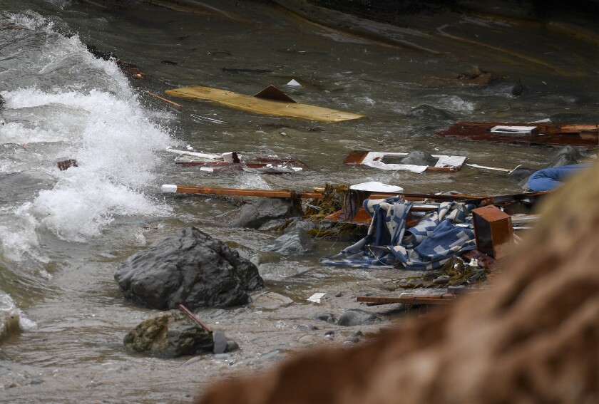 FILE - Wreckage and debris from a capsized boat washes ashore at Cabrillo National Monument near where a boat capsized just off the coast on Sunday, May 2, 2021, in San Diego. Antonio Hurtado, the captain of the overloaded smuggling boat that crashed into rocks and broke up off the San Diego coast last year, killing three immigrants, pleaded guilty Wednesday, April 6, 2022, to federal charges. (AP Photo/Denis Poroy, File)
