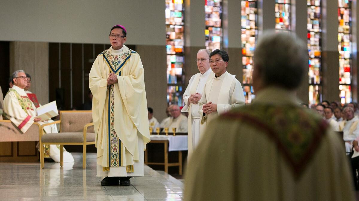 The Rev. Thomas Thanh Thai Nguyen listens as the Mandate from the Apostolic See is read on Dec. 19.