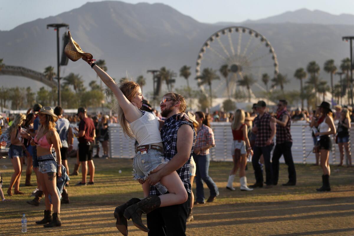 Faith Edwards kicks up her heels with Nick Mitchell as the Corona couple enjoys Chris Janson's performance.