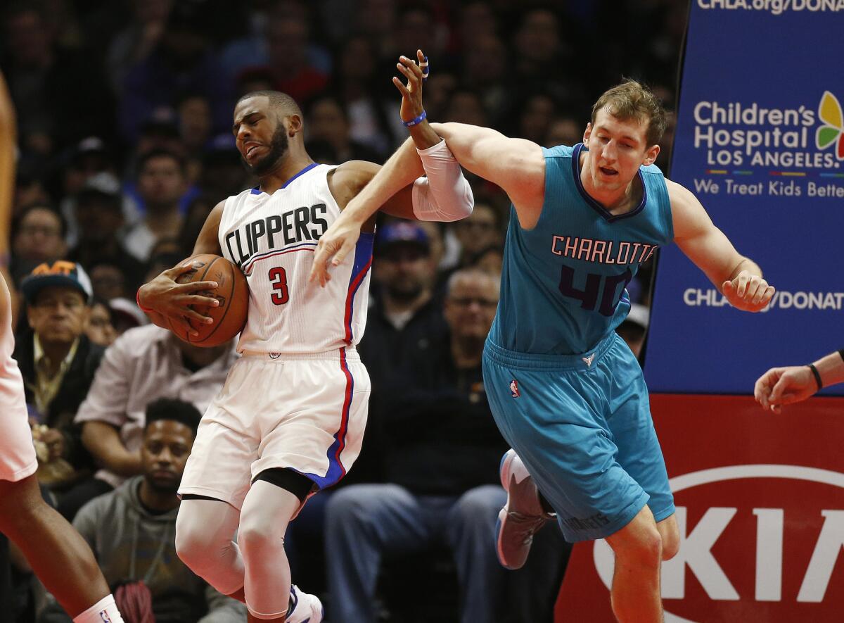 Clippers guard Chris Paul (3) is fouled by Hornets center Cody Zeller (40) during the first half.
