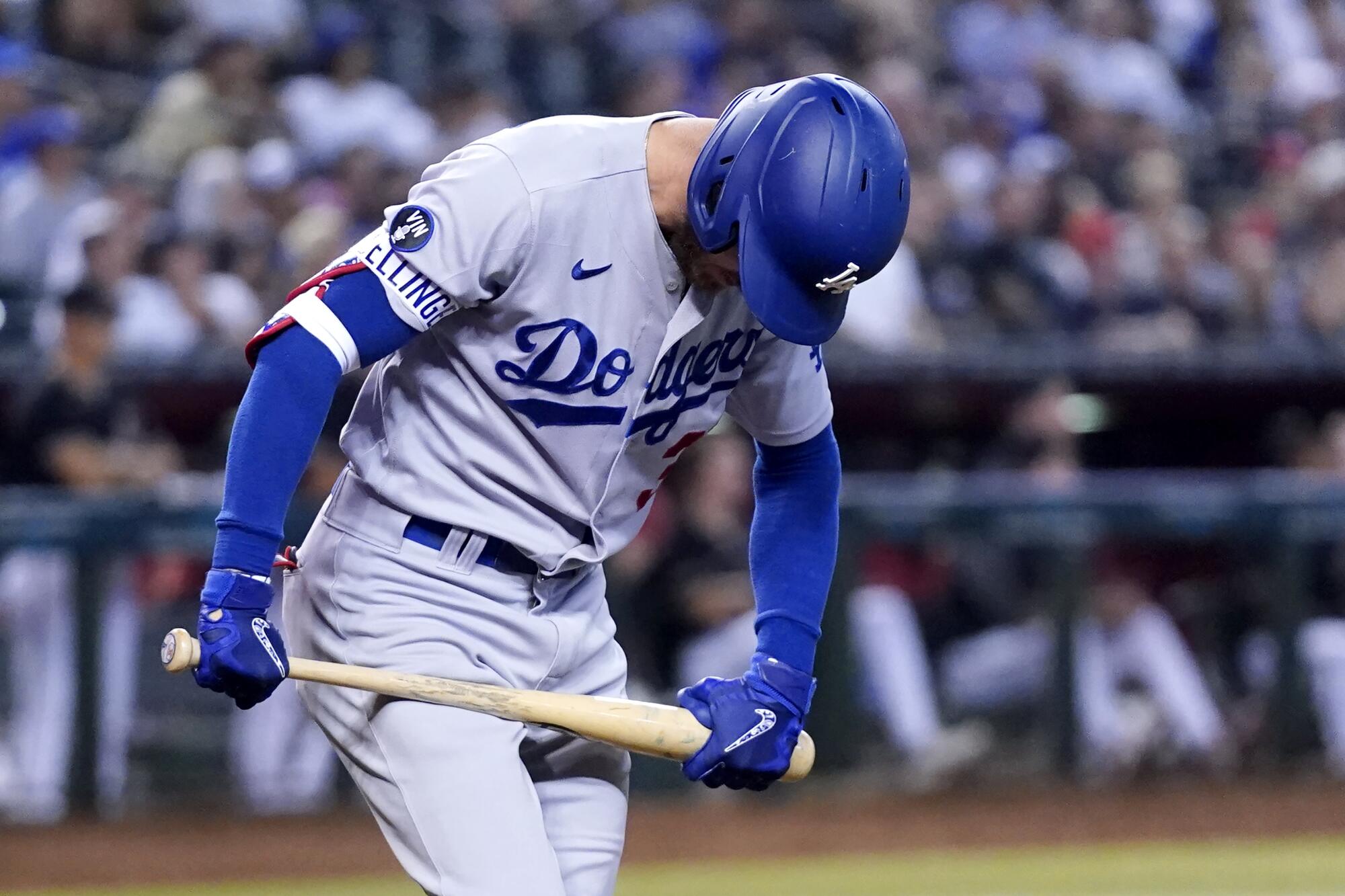 The Dodgers' Cody Bellinger tries to break his bat as he flies out during the fourth inning against the Diamondbacks