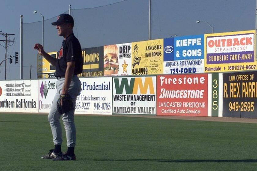 Advertisements add a touch of color to the outfield walls at the JetHawks' stadium in Lancaster