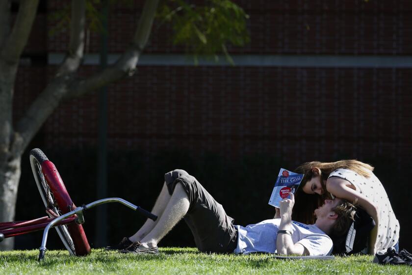 USC students Pat Corcoran and Alexandra Plzak enjoy the warm weather on campus Tuesday as temperatures reached a record 87 degrees in downtown Los Angeles.