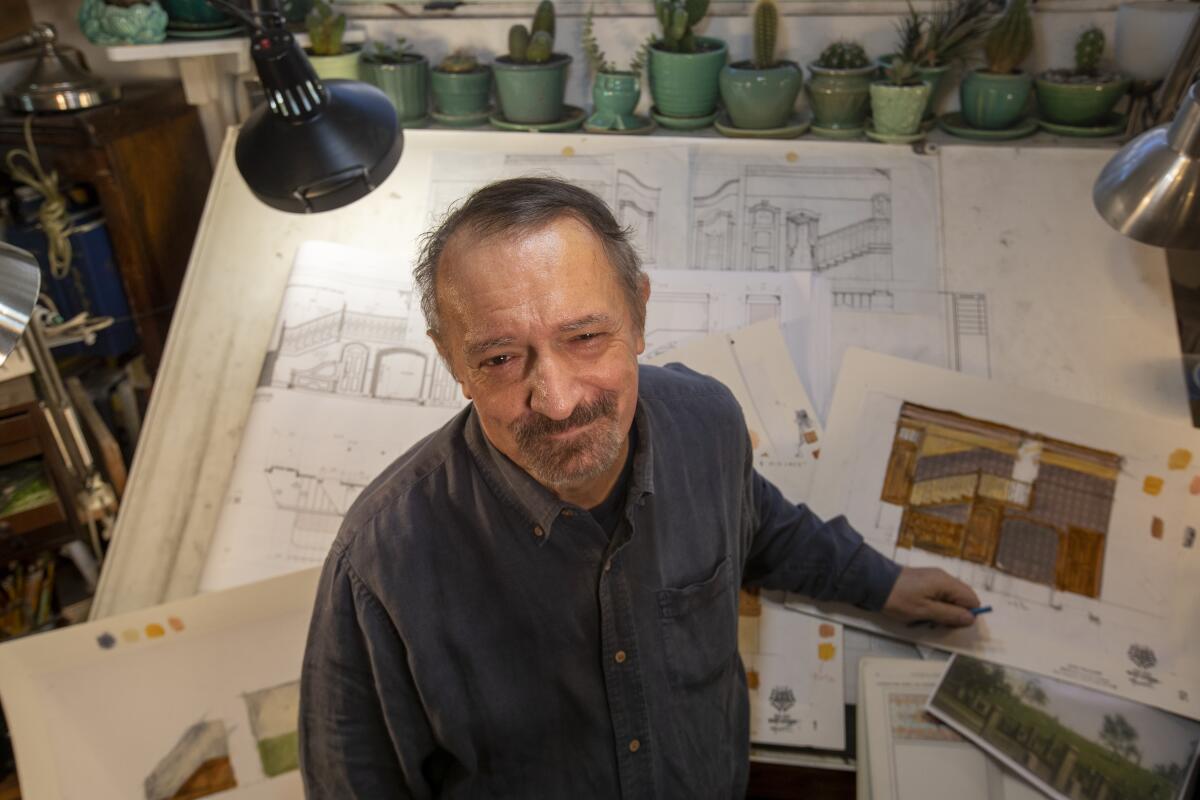  Scenic designer John Iacovelli stands in front of drawings.