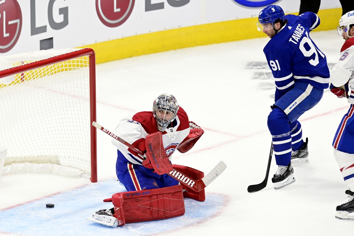 Toronto Maple Leafs' John Tavares (91) scores on Montreal Canadiens goaltender Carey Price (31) during the first period of an NHL hockey game Wednesday, Jan. 13, 2021 in Toronto. (Frank Gunn/The Canadian Press via AP)