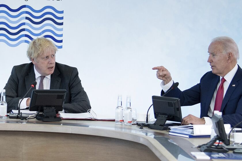 Britain's Prime Minister Boris Johnson, left, listens to US President Joe Biden during a working session at the G7 summit in Carbis Bay, Cornwall, England, Saturday, June 12, 2021. (Brendan Smialowski/Pool Photo via AP)