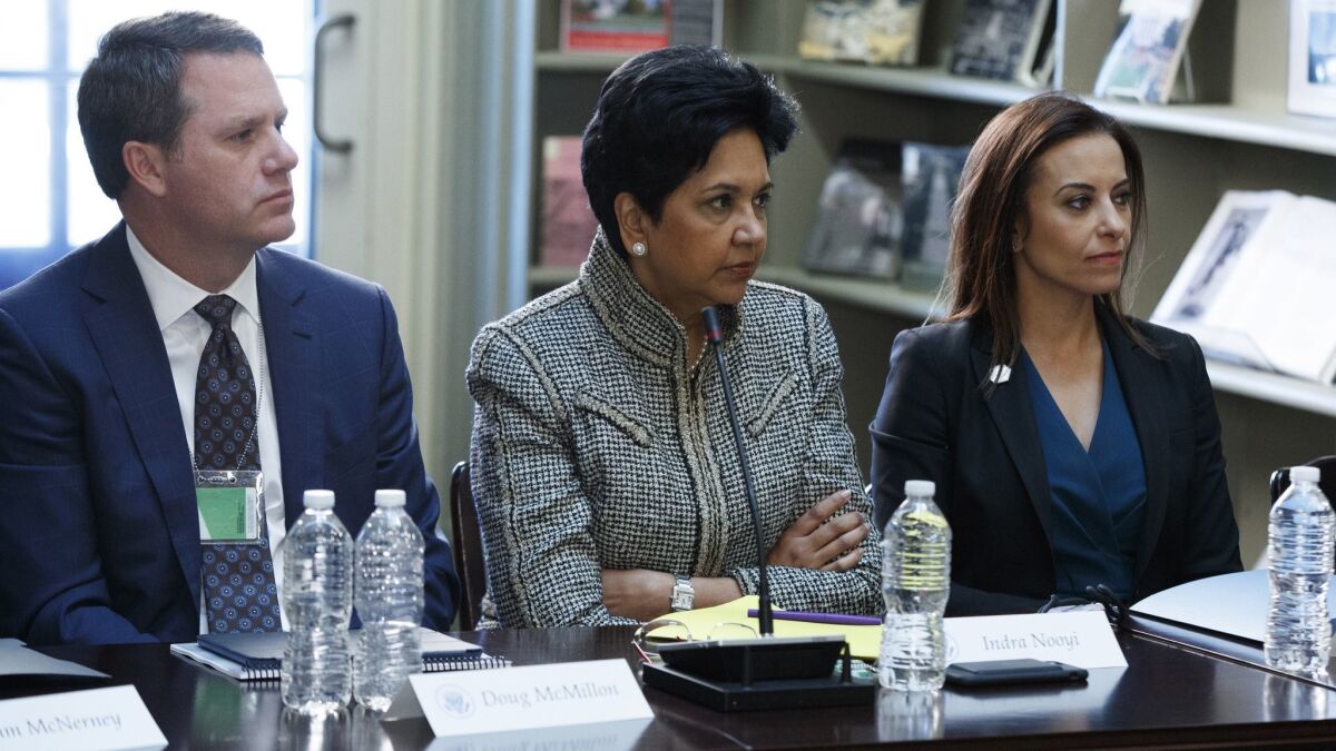 In this Aug. 11, 2017 photo, from left, Wal-Mart CEO Doug McMillon, Pepsi CEO Indra Nooyi, and Dina Powell, President Donald Trump's senior counselor for economic initiatives listen during a meeting with business leaders in Washington, D.C.