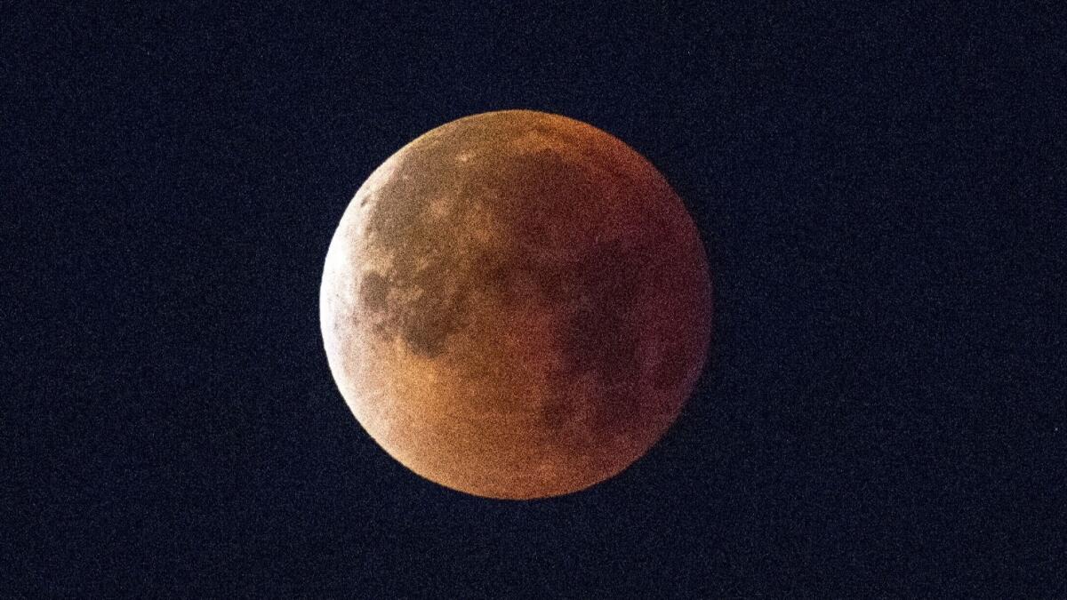 A Super Blue Blood Moon sets over downtown Los Angeles on Jan. 31.
