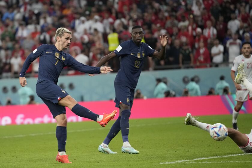 France's Antoine Griezmann, left, kicks the ball to score his side opening goal that was later disallowed during the World Cup group D soccer match between Tunisia and France at the Education City Stadium in Al Rayyan , Qatar, Wednesday, Nov. 30, 2022. (AP Photo/Christophe Ena)