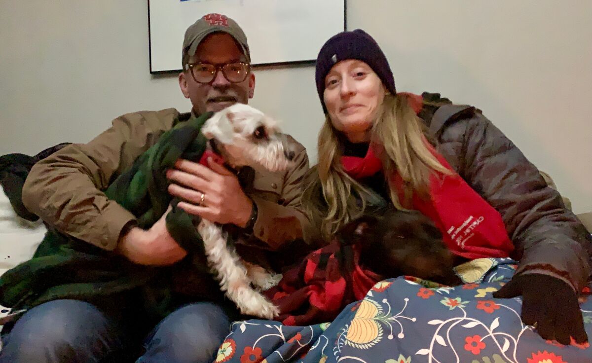 Molly Hennessy-Fiske with her husband and dog