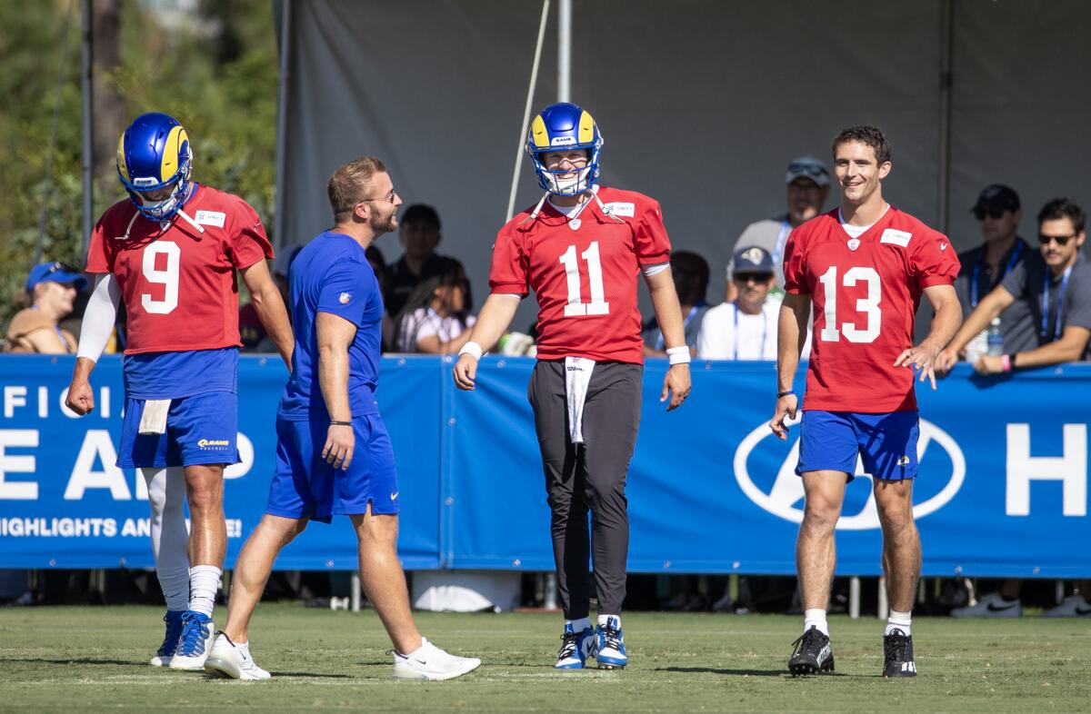 Rams coach Sean McVay talks with quarterbacks (from left) Matthew Stafford,  Brett Rypien and Stetson Bennett.