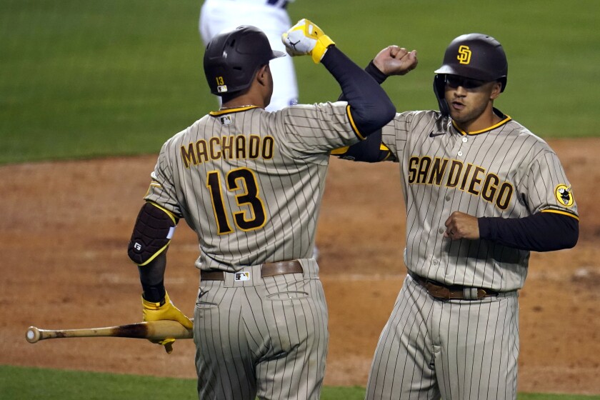 The Padres' Trent Grisham, right, celebrates his solo home run with Manny Machado (13) 