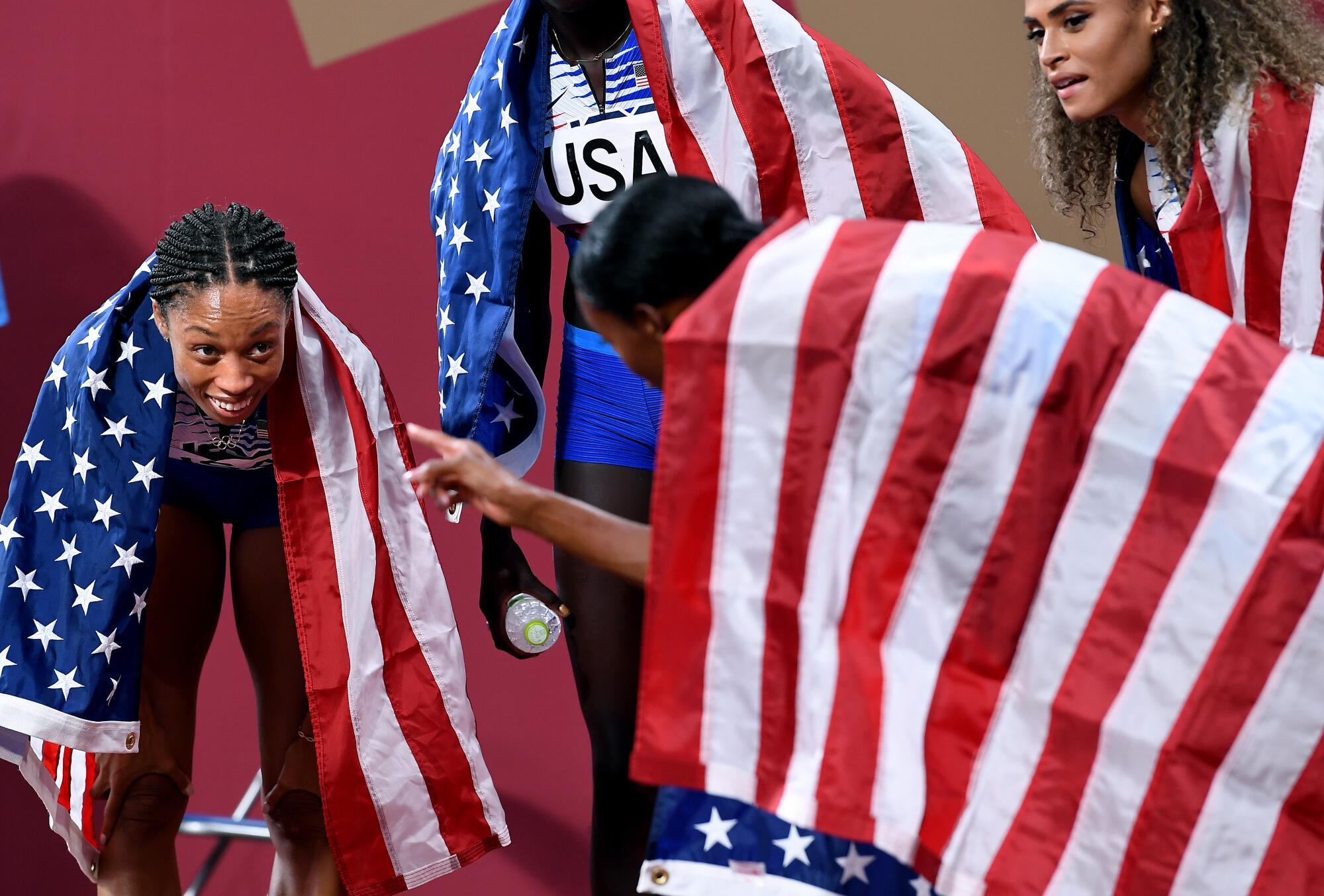  USA's Allyson Felix smiles after winning the gold medal in the 4X400 relay.