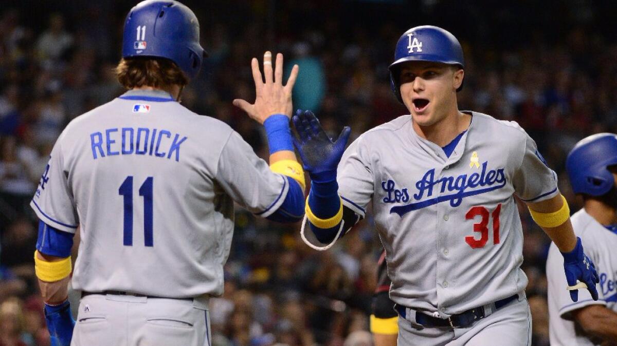 Joc Pederson is congratulated by fellow Dodgers outfielder Josh Reddick after hitting a two-run home run during the fourth inning of a game on Sept. 17.