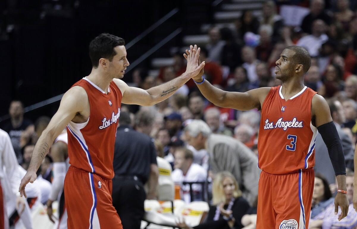 Clippers guard Chris Paul, right, high-fives teammate J.J. Redick on Wednesday night against Portland.
