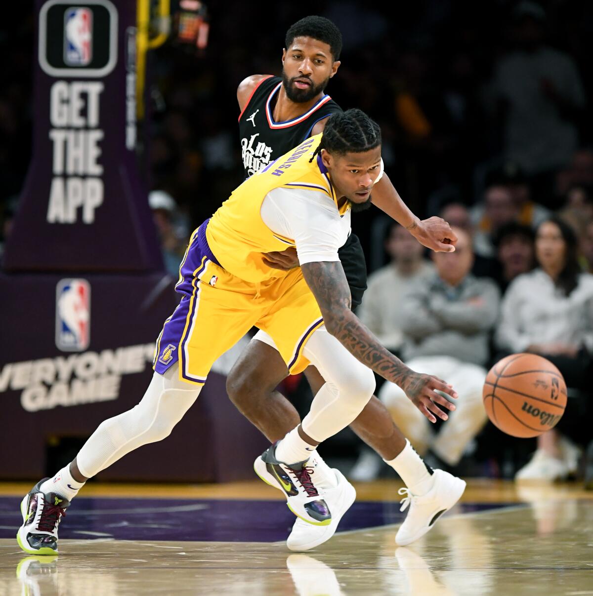 Lakers Cam Reddish steals the ball away from Clippers Paul George.