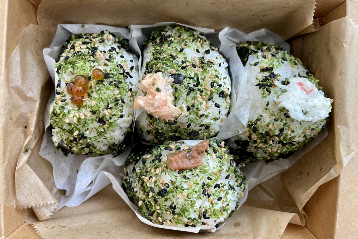 overhead view of onigiri in a takeout box 