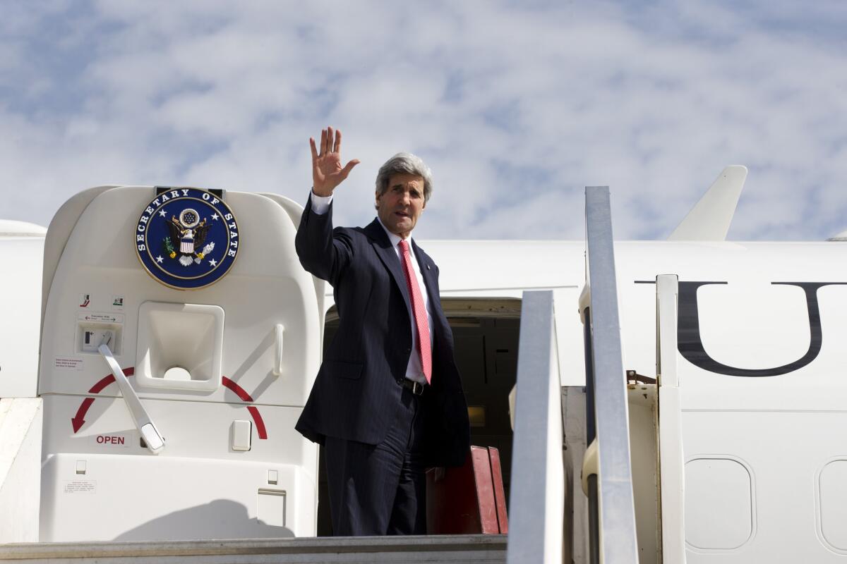 Secretary of State John F. Kerry waves as he leaves Tel Aviv, Israel.
