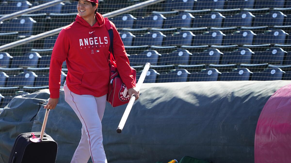 Shohei Ohtani of the Los Angeles Angels reacts after drawing a walk in the  fifth inning of a spring training baseball game against the Chicago Cubs on  March 24, 2022, in Tempe