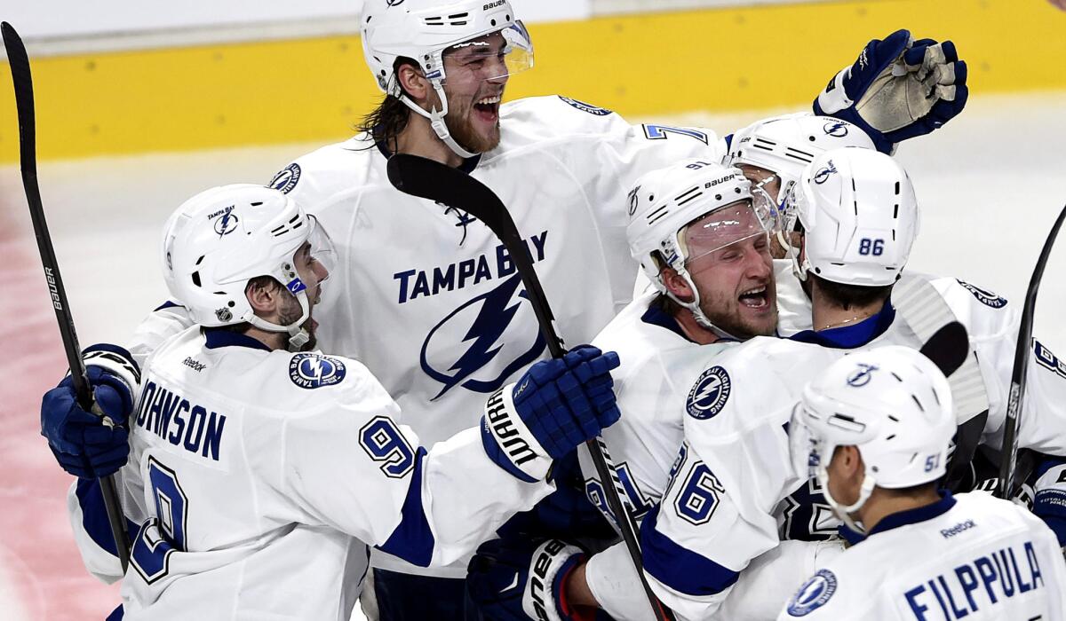 Lightning right wing Nikita Kucherov (86) is hugged by center Steven Stamkos (91) after scoring the winning goal against the Canadiens in the second overtime Friday night.