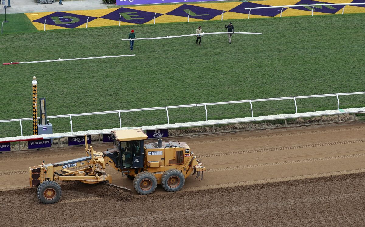 Workers on Tuesday prepare the tracks for this weekend's Breeders' Cup at Del Mar.