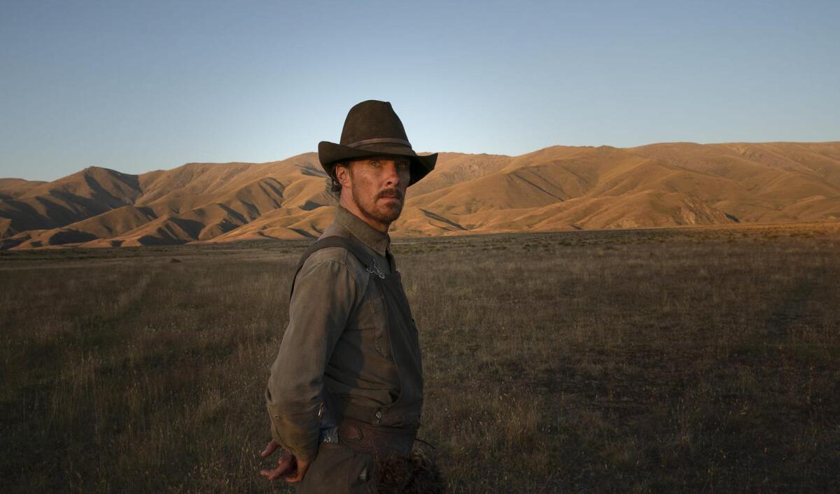 A bearded man in a hat stands in front of mountains in "The Power of the Dog." 