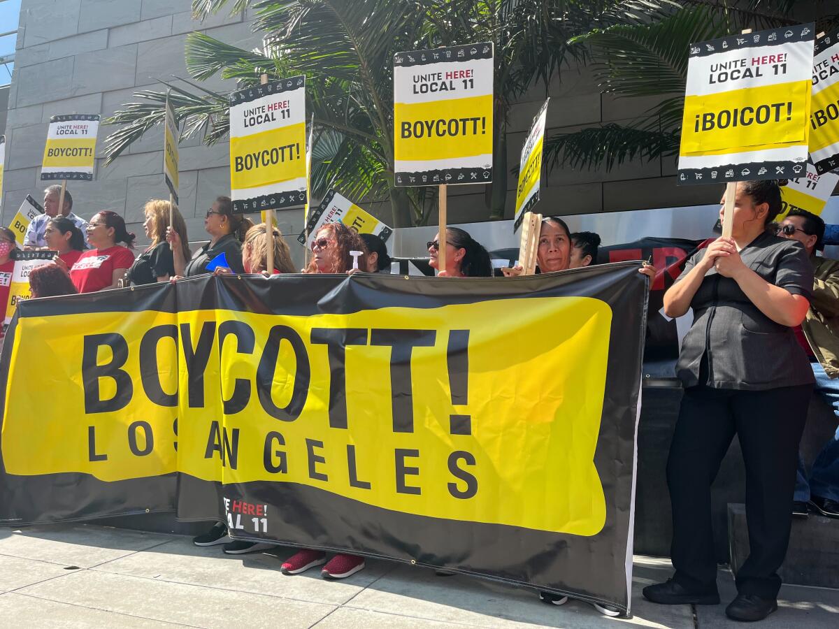 Hotel workers in front of a sign reading Boycott Los Angeles