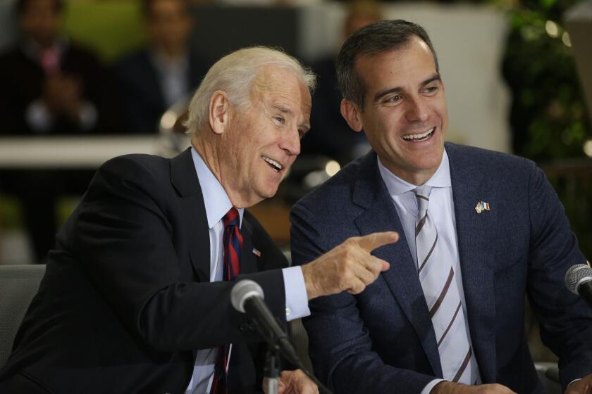FILE - In this Nov. 16, 2015 file photo, Democratic presidential candidate former Vice President Joe Biden, left, talks to Los Angeles Mayor Eric Garcetti during a roundtable discussion in Los Angeles. The 2020 vice presidential search now rests with Democratic presidential candidate Joe Biden as he prepares to pick just the third woman in history for a major U.S. party's national ticket. There's a group of key advisers who have helped shape his options and present him with reams of pros and cons for potential vice presidents. They include Delaware Rep. Lisa Blunt Rochester, former Connecticut Sen. Chris Dodd, Los Angeles Mayor Eric Garcetti and former Apple executive and longtime Biden adviser Cynthia Hogan. They're aided by lawyers with deep ties to Democratic politics and former President Barack Obama. (AP Photo/Jae C. Hong)