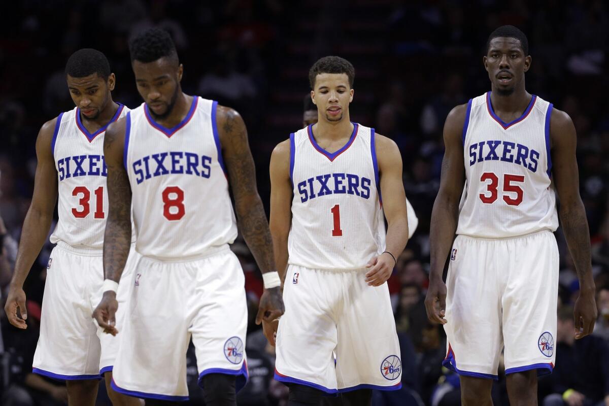 Philadelphia 76ers' Hollis Thompson, left, Tony Wroten, Michael Carter-Williams and Henry Sims walk onto the court after a timeout during their game Wednesday against the Boston Celtics.