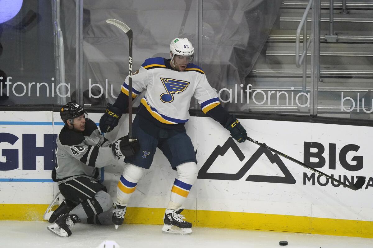 St. Louis Blues left wing David Perron, right, collides with the boards next to Los Angeles Kings center Blake Lizotte during the first period of an NHL hockey game Saturday, March 6, 2021, in Los Angeles. (AP Photo/Marcio Jose Sanchez)