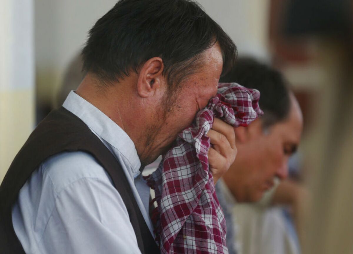 A man weeps Aug. 21 during a memorial service for victims of a wedding hall bombing in Kabul, Afghanistan.