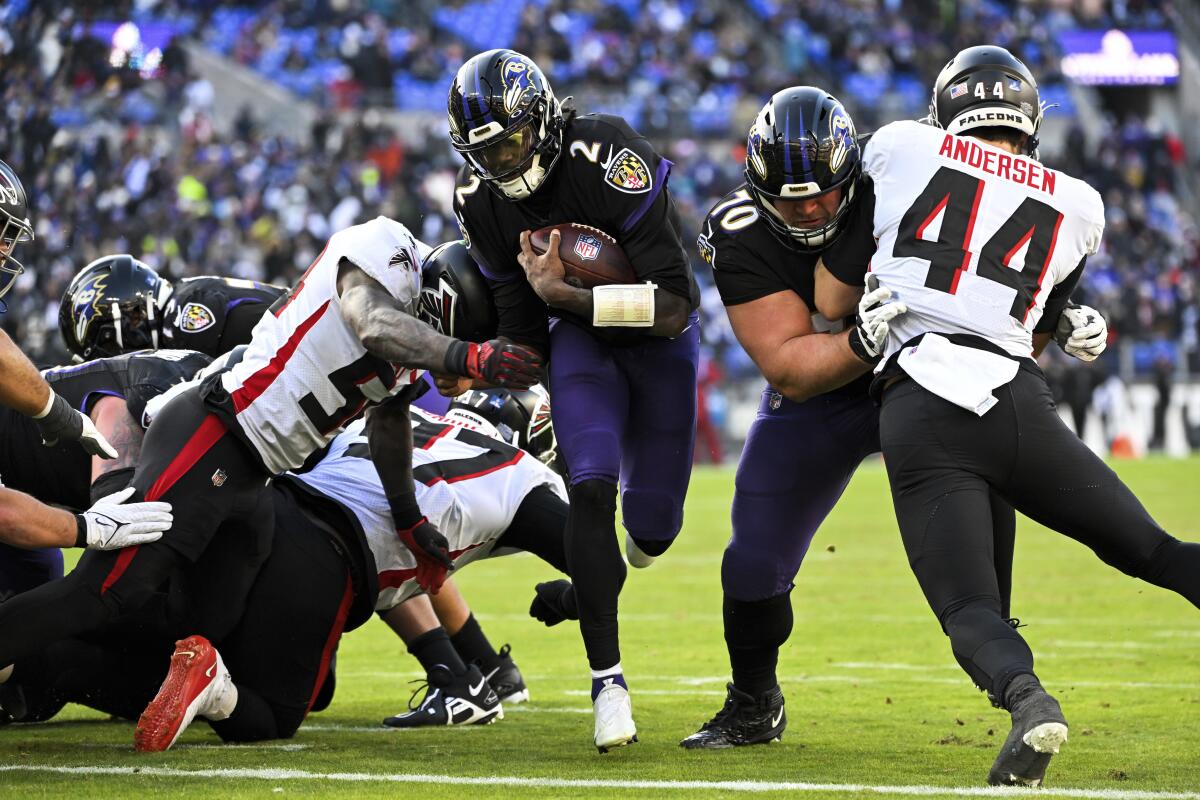 Baltimore Ravens quarterback Tyler Huntley carries the ball to score on a two-point conversion against the Atlanta Falcons.