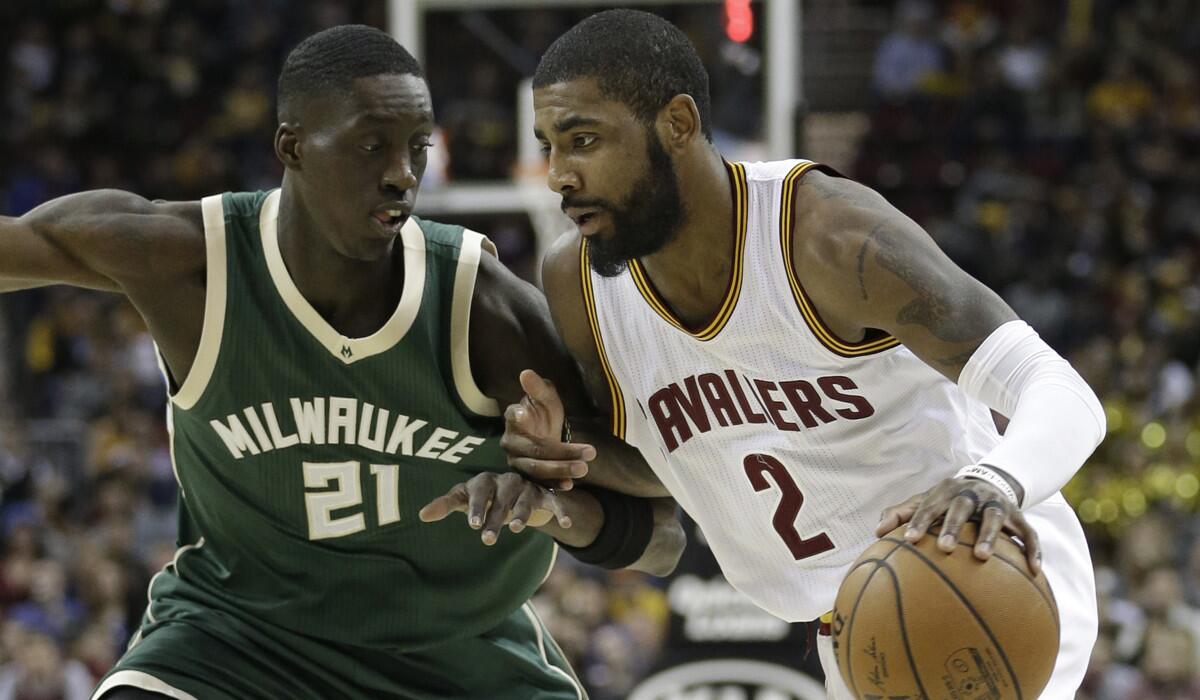 Cleveland Cavaliers' Kyrie Irving (2) drives past Milwaukee Bucks' Tony Snell (21) during the first half on Wednesday.