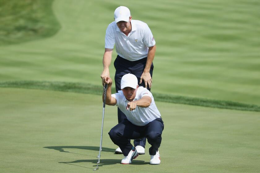Jimmy Walker and Rickie Fowler of the United States Team look over the first green during the Thursday foursomes matches at The Presidents Cup in South Korea.