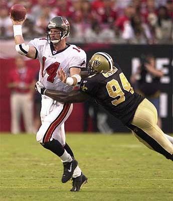 Bucs' quarterback Brad Johnson is pressured late in the 4th quarter by New Orleans' Charles Grant.