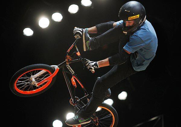 A competitor flies through the air while competing in the Men's BMX Freestyle Vert Final at the ESPN X Games 16 at the Nokia Theatre in Los Angeles.