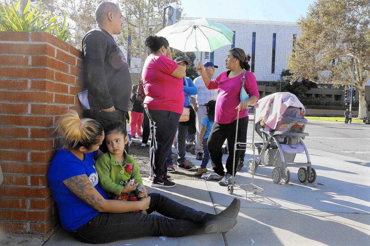 Needy families wait to sign up to receive a Christmas food basket and toys as part of the El Monte Police Department's annual holiday giveaway. In the densely populated city of 113,000, nearly a quarter of the population lives below the poverty line.