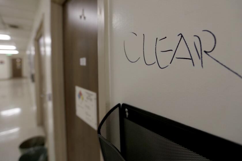 The word "clear" written on a wall near smashed doors on the fourth floor of the Engineering Building.