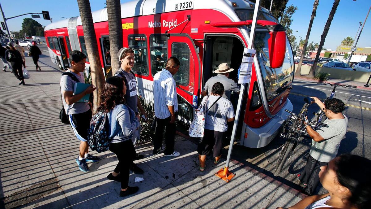 Passengers board a Metro Rapid bus on Vermont Avenue in South Los Angeles. 