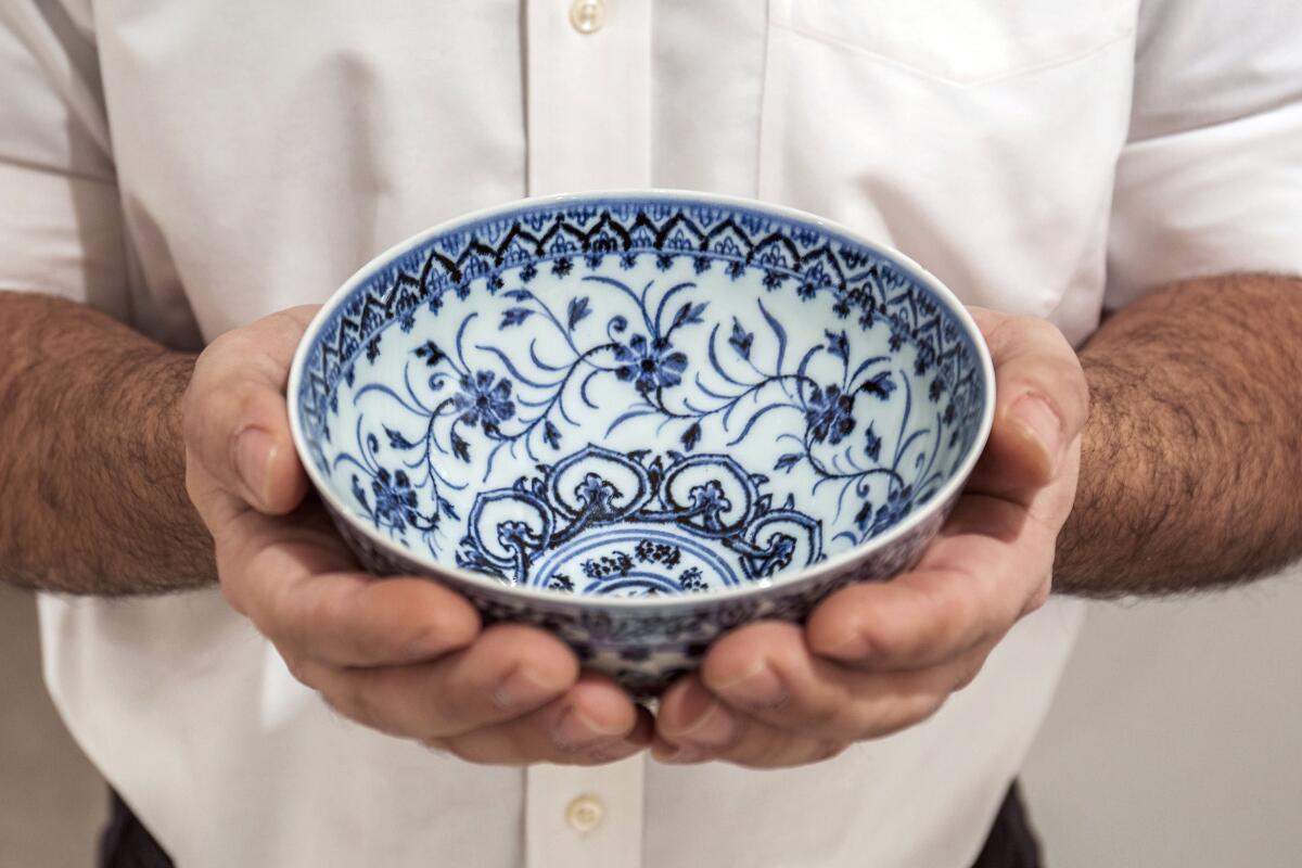 This photo, provided by Sotheby's, in New York, on Tuesday, March 2, 2021, shows a small porcelain bowl bought for $35 at a Connecticut yard sale that turned out to be a rare, 15th century Chinese artifact worth between $300,000 and $500,000. The bowl will be offered in Sotheby's Auction of Important Chinese Art, in New York, on March 17. (Sotheby's via AP)