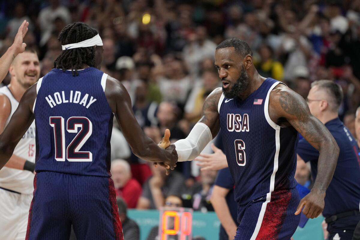 LeBron James, right, of the United States, celebrates with Jrue Holiday, of the United States.