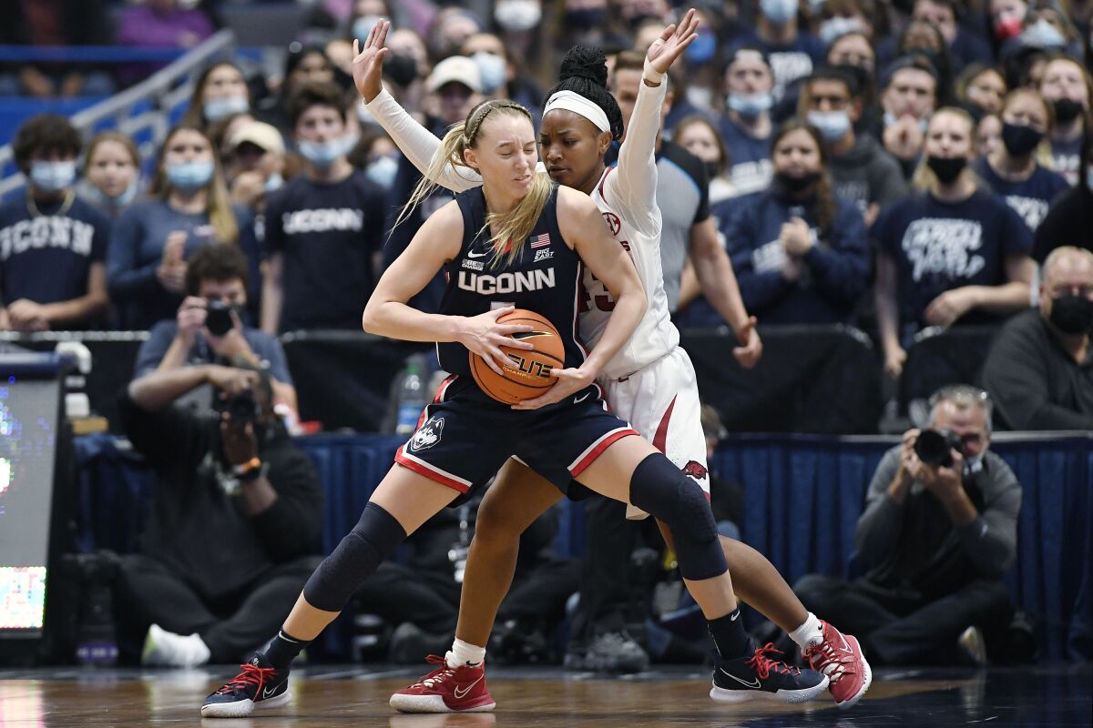 Connecticut's Paige Bueckers is guarded by Arkansas' Makayla Daniels, right, in the first half of an NCAA college basketball game, Sunday, Nov. 14, 2021, in Hartford, Conn. (AP Photo/Jessica Hill)
