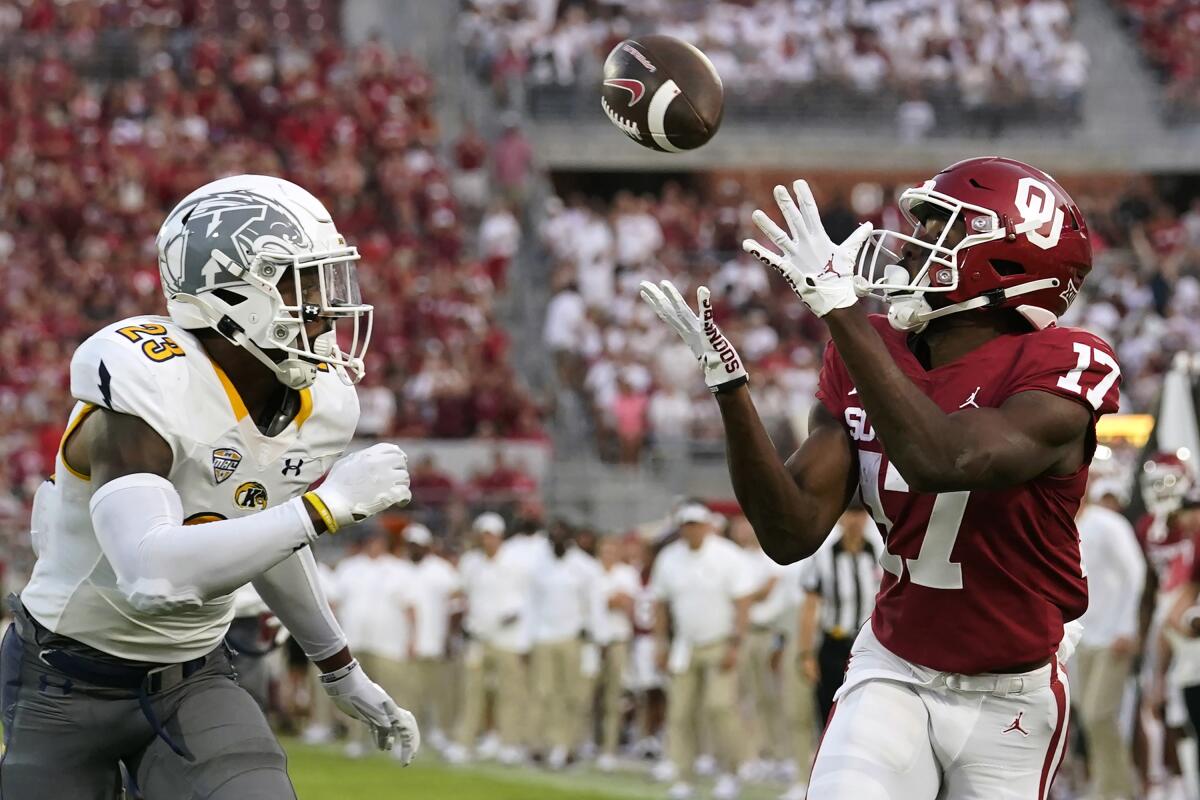 Oklahoma wide receiver Marvin Mims (17) catches a touchdown pass in front of Kent State safety JoJo Evans (23) in the first half of an NCAA college football game, Saturday, Sept. 10, 2022, in Norman, Okla. (AP Photo/Sue Ogrocki)