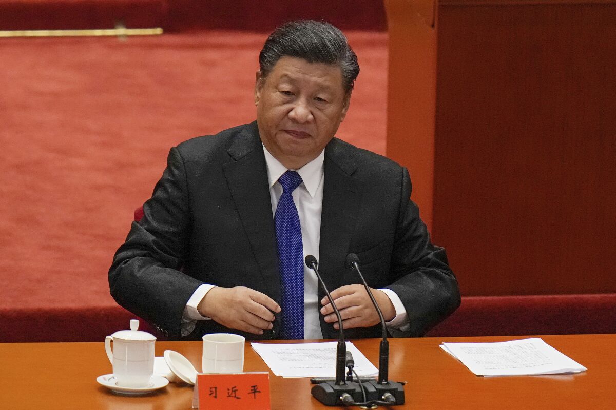 Chinese President Xi Jinping looks as he arrives at an event commemorating the 110th anniversary of Xinhai Revolution at the Great Hall of the People in Beijing, Saturday, Oct. 9, 2021. Xi said on Saturday reunification with Taiwan must happen and will happen peacefully, despite a ratcheting-up of China's threats to attack the island. (AP Photo/Andy Wong)